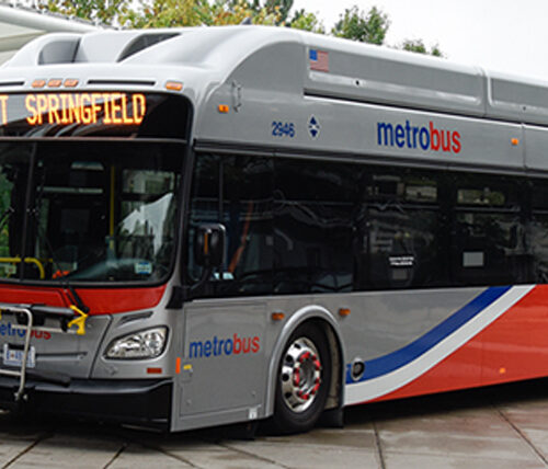 gray metro bus with blue, white, and red stripes