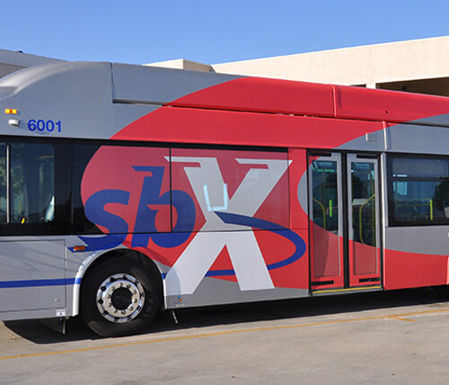 gray and red metro bus