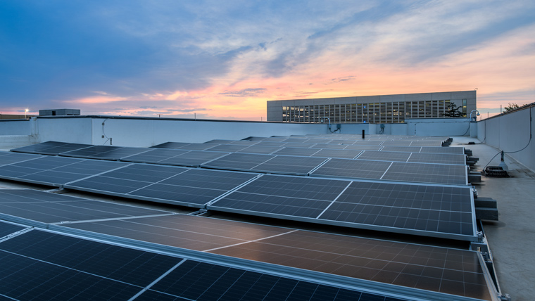 Rooftop with solar panels and evening sky