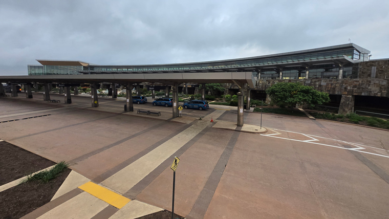 exterior of airport with passenger dropoff