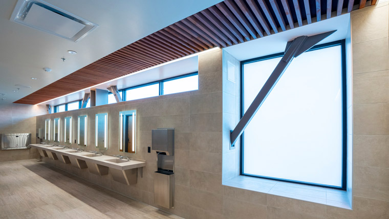 interior of the restroom sinks with large frosted windows