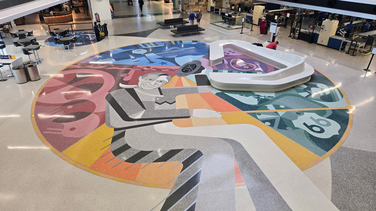 interior of airport, multicolor terrazzo art on floor depicting various oklahoma representations