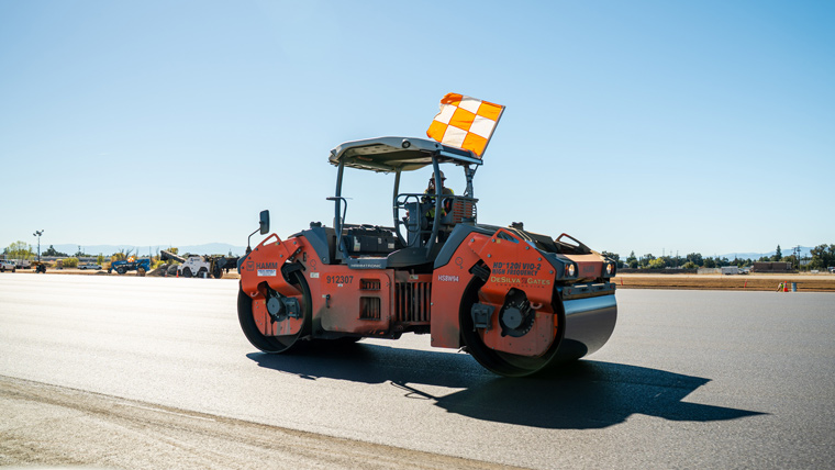 Steam roller on newly paved runway