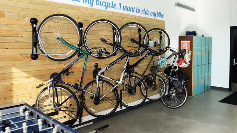 four bicycles hang vertically on the bike wall