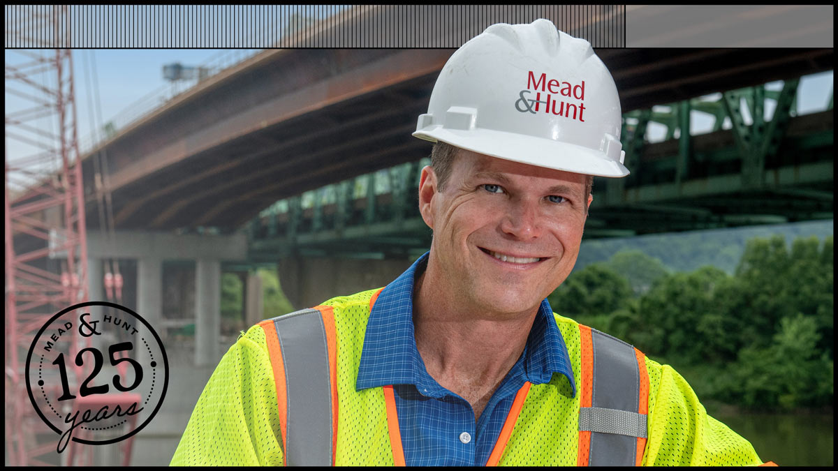 Jamie Bumgarner in a Mead & Hunt hardhat and yellow vest at a job site