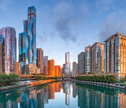 chicago's riverwalk, overlooking the river and surrounding city with sunrise sky