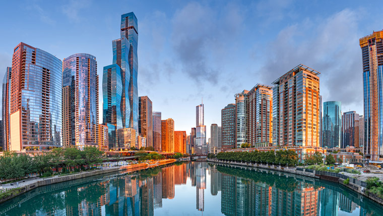 chicago's riverwalk, overlooking the river and surrounding city with sunrise sky