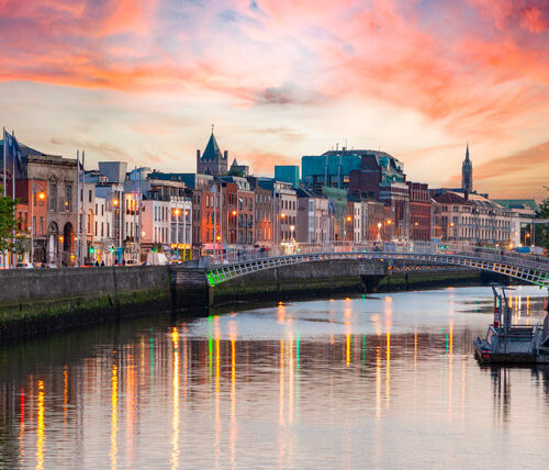 Dublin cityscape with water reflecting colorful evening sky