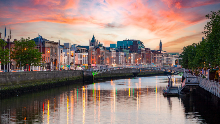 Dublin cityscape with water reflecting colorful evening sky