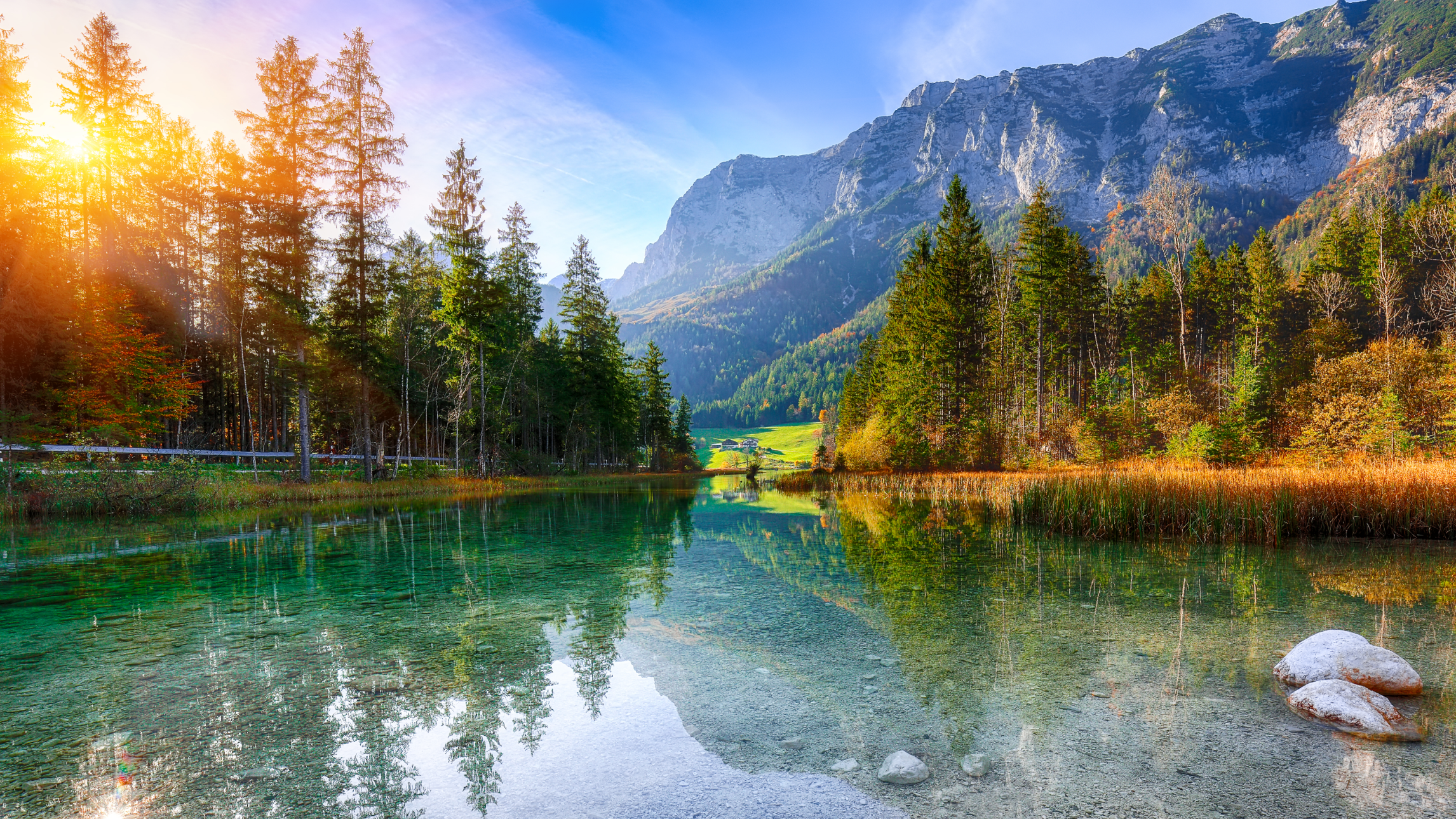 Beautiful scenery featuring a lake, trees, and mountains.