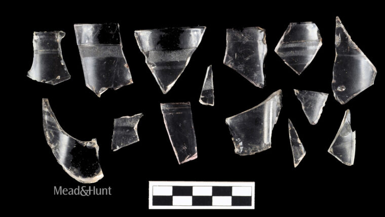 Various glass jelly juice jar fragments displayed against a black backdrop. Some have patterns and bands.