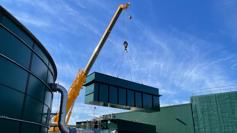 Crane installing a large unit