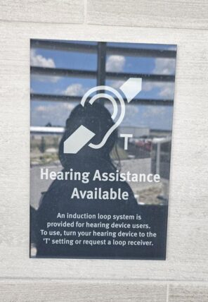 A hearing loop sign at Fort Wayne International Airport. The system helps travelers with compatible hearing aids and cochlear implants hear announcements and conversations more clearly.