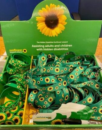 Display of sunflower-patterned lanyards and wristbands used in the Hidden Disabilities Sunflower Program.