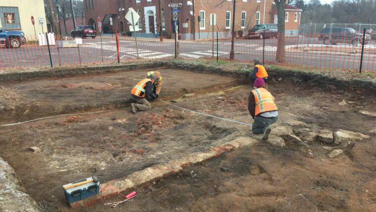Dovetail archaeologists digging in a dirt pit