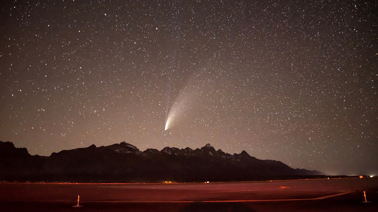 Night sky covered in stars, over a runway