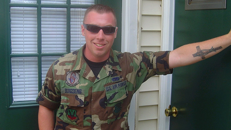 Man in military gear stands in doorway