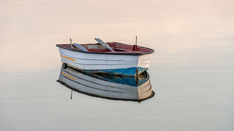 Lone boat sits in a large body of water