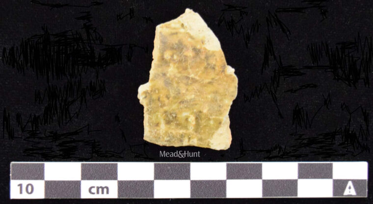 Historical gravel sherd next to a measuring stick