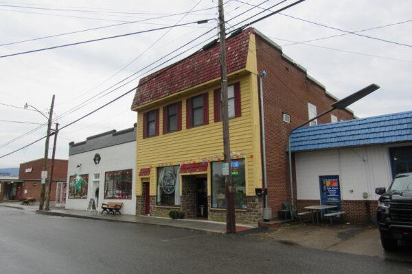 Large yellow building with a storefront.
