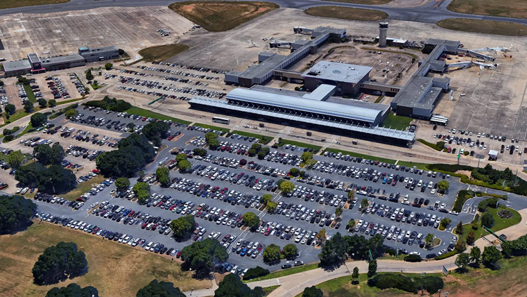 aerial view of airport, parking lot in foreground