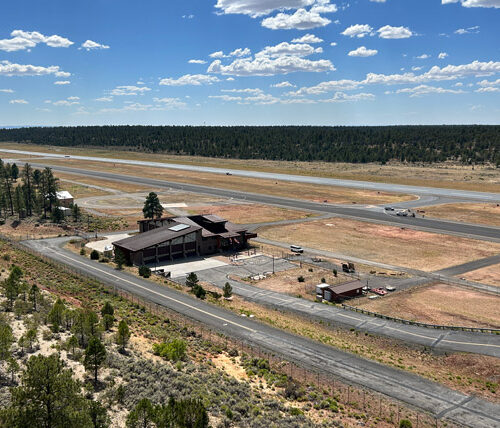 Aerial shot of Grand Canyon National Park Airport building with runway in the background