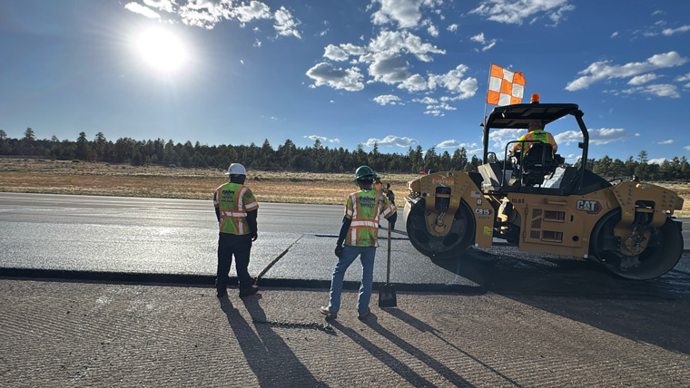 Construction workers laying asphalt