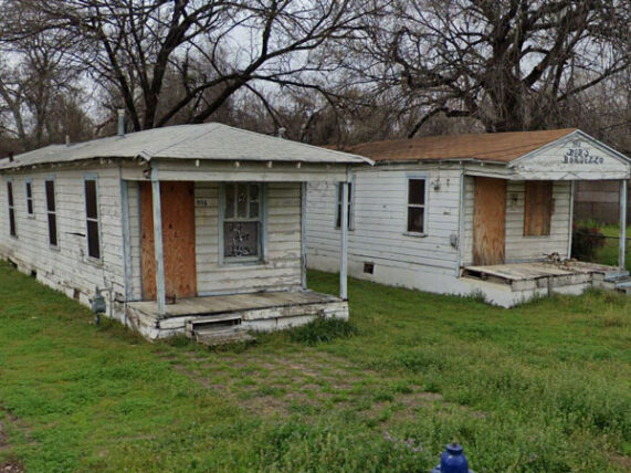 two shotgun houses boarded up