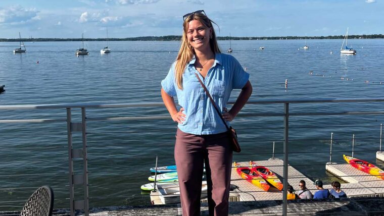 Vanessa stands near the waterfront in Madison Wisconsin on a sunny day