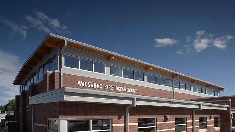 Close up of Waunakee fire department with name displayed on brick building