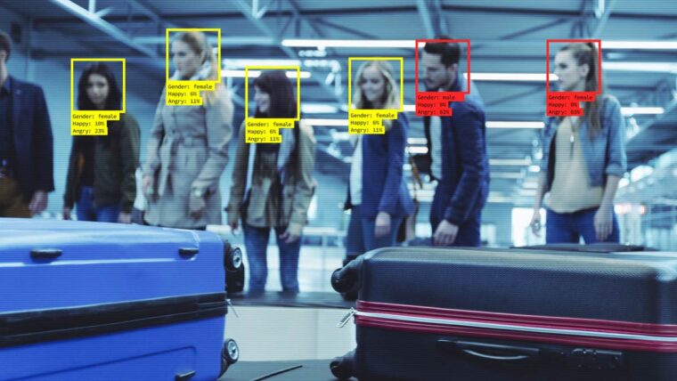 the view from an airport luggage carousel security camers shows facial recognition with boxes around each person's face with their gender and sentiment