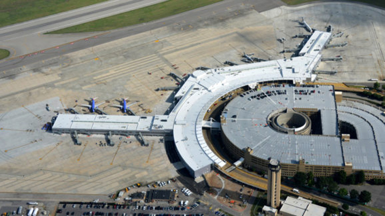 aerial shot of exterior of airport with planes at gates