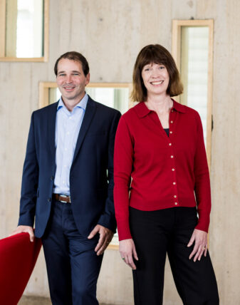 Troy and Amy stand side by side