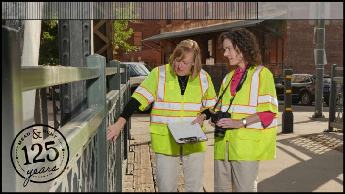 Mead & Hunt’s Cultural Resources team leader Christina Slattery mentoring a colleague on a historic bridge.