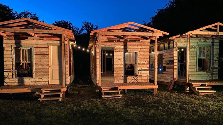 3 shotgun houses in the evening with a string of lights