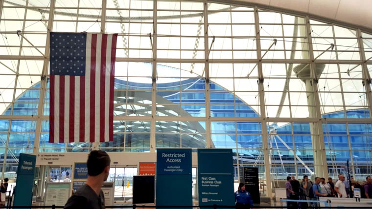 interior of denver airport with large windows and an American flag