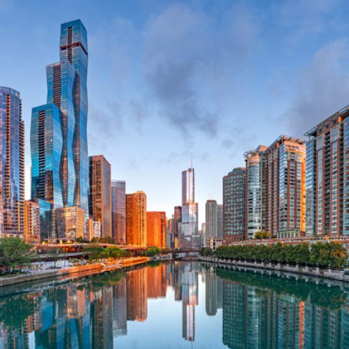 chicago's riverwalk, overlooking the river and surrounding city with sunrise sky