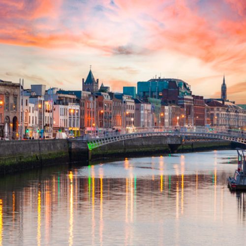 Dublin cityscape with water reflecting colorful evening sky