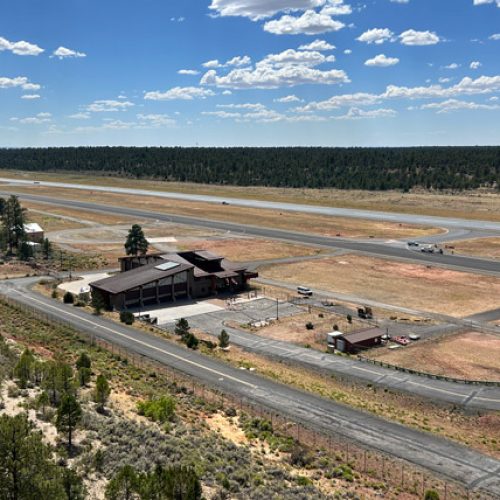 Aerial shot of Grand Canyon National Park Airport building with runway in the background