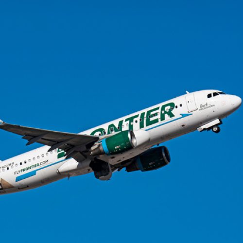 Frontier Airlines A320 N233FR airplane flying in a blue sky