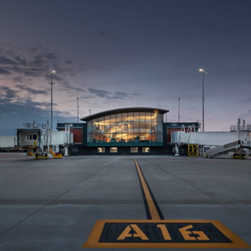 Gerald R Ford airport exterior at dusk, warm lights from building in the center