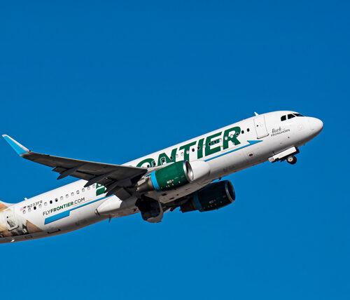 Frontier Airlines A320 N233FR airplane flying in a blue sky