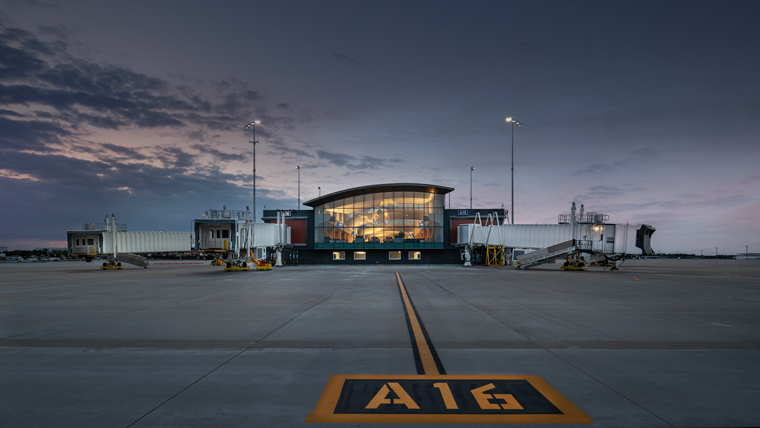 Gerald R Ford airport exterior at dusk, warm lights from building in the center