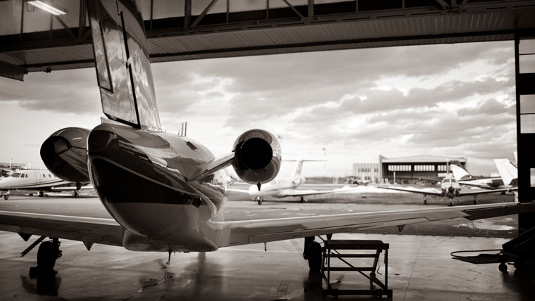 view from the back of a hangar showing a small plane