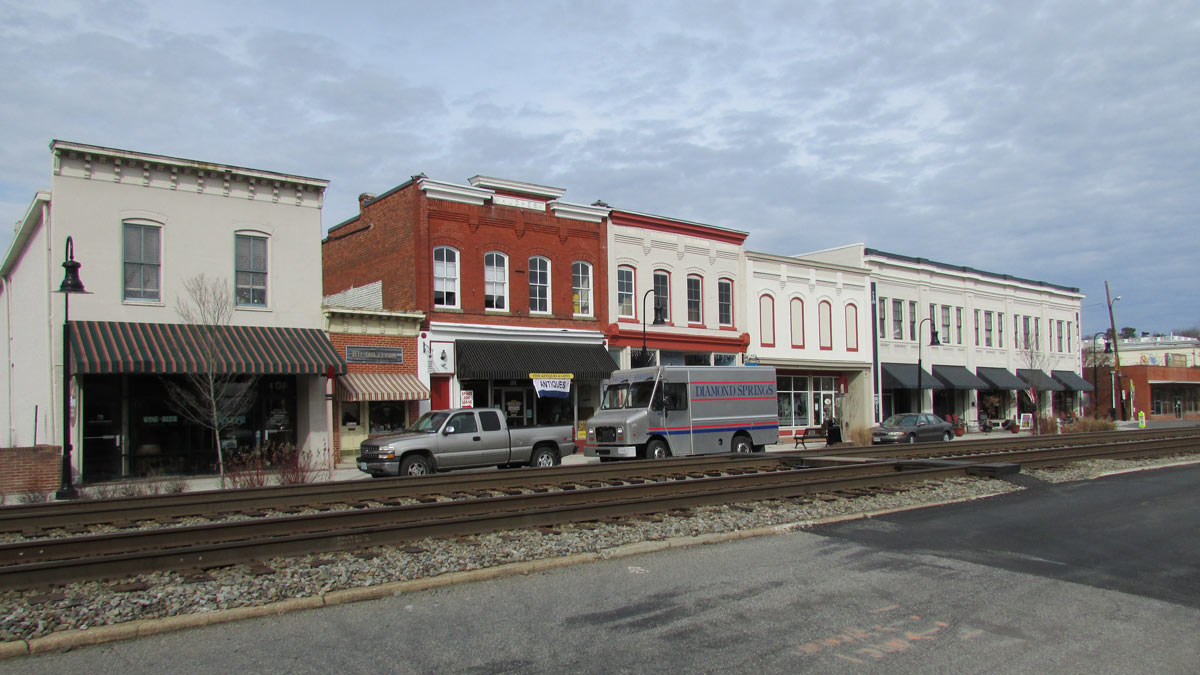 a historic downtown with modern cars lining the street