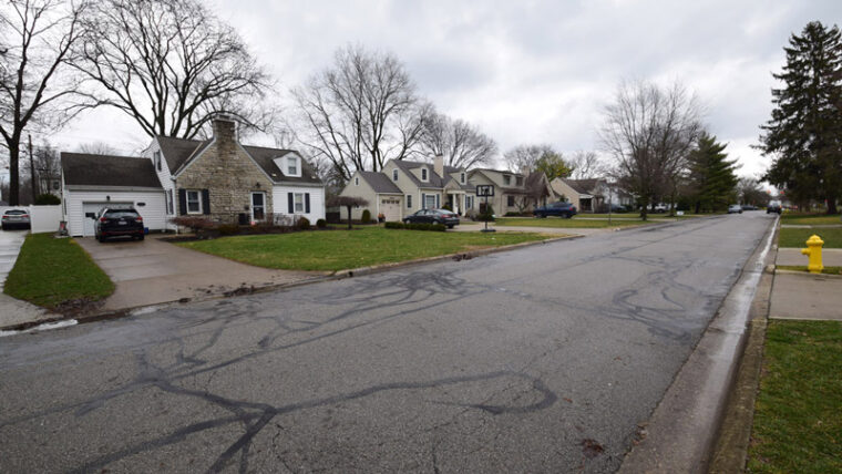 Postwar ranch-style houses on a tree-lined street in an Ohio subdivision.