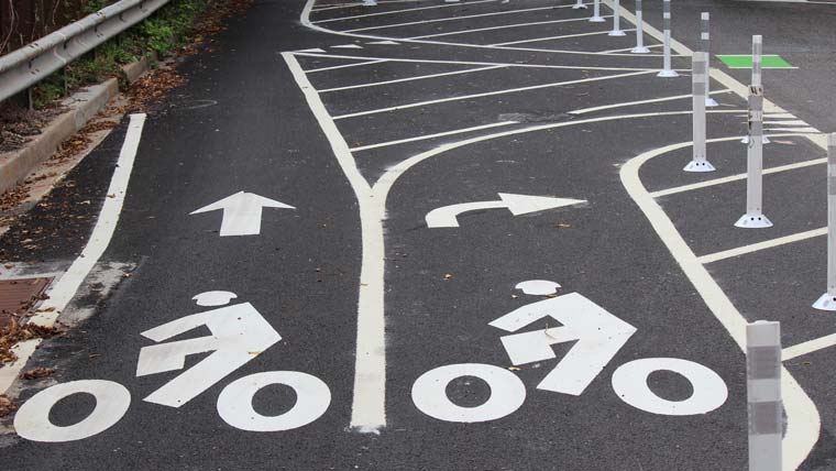 a path is painted to show a bike lane and turning bike lane