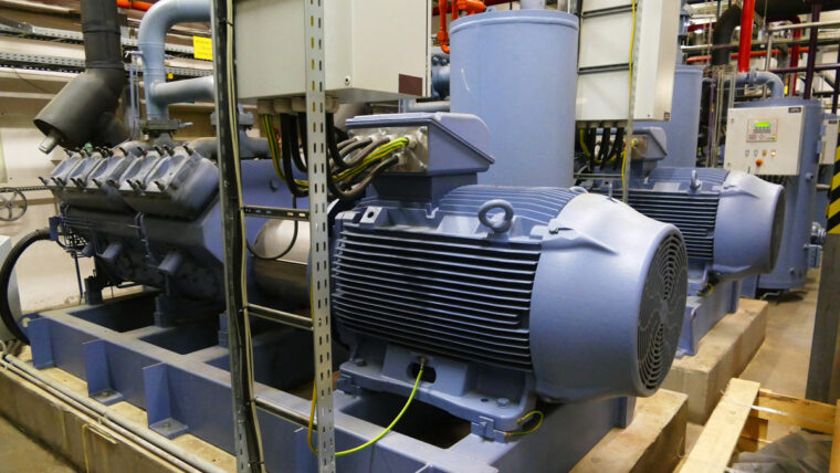 Gray tank of an industrial ammonia refrigeration system set in a manufacturing facility.