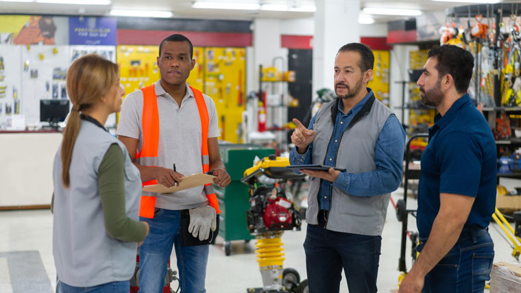 group of four vendors talking in a hardware store
